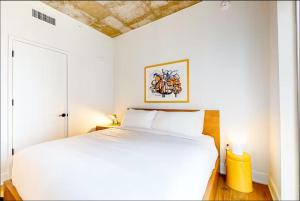 a white bedroom with a white bed and a ceiling at Austin Downtown Condo - 1BR Lakeview 23rd-floor in Austin