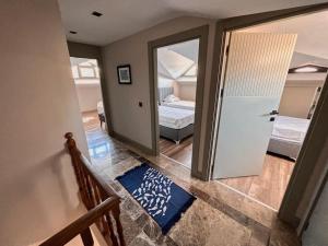 a hallway with a door leading to a bedroom with two beds at Kemer Green Park Villa in Kemer +9 photos