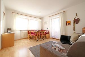 a living room with a couch and a table at Ciasa Rudiferia Appartamenti in Alta Badia in Badia +57 photos