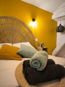 a bedroom with a large bed with a towel on it at Clementenia - Maison d'hôtes in Arnéguy +47 photos