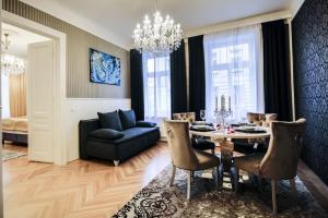 a living room with a table and a couch at Sophie's Place Augarten - Lifestyle City Apartments Vienna Parking in Vienna