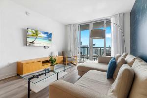 a living room with a couch and a table at Top Luxury Apartment with Pool & Gym in Hallandale Beach +37 photos