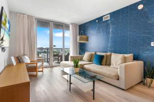 a living room with a couch and a table at Top Luxury Apartment with Pool & Gym in Hallandale Beach