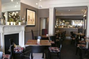 a restaurant with tables and chairs and a bar at The Townhouse Hotel in Melrose