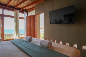 a bedroom with a bed and a large window at Casa Kahu by Wynwood House in Los Órganos +55 photos