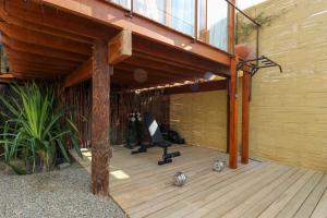 a wooden deck with a chair on top of it at Casa Kahu by Wynwood House in Los Órganos