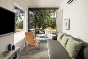 a living room with a couch and a tv at ParcBlu in Fredericksburg