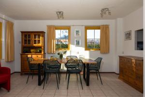 a dining room with a table and chairs at Tulip Beach in De Zandloper
