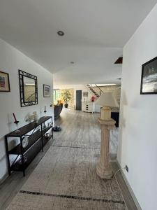 a large living room with a table and a lamp at Loft au bord de l'eau in Nevers