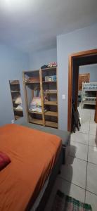 En eller flere senge i et værelse på Casa aconchegante com piscina em Nova Tramandai