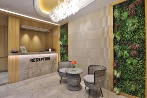a reception area with two chairs and a table at Hotel Bawa Inn in Surat