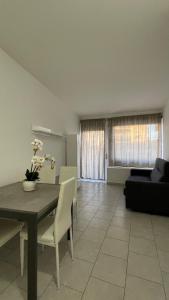 a living room with a table and a couch at Sweet Home in Santa Marinella