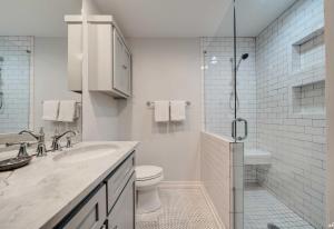 a white bathroom with a toilet and a shower at Luxury Family Beach Front Property! Family Oriented! Gulf Views! in Panama City Beach +27 photos