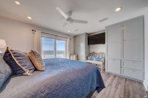 a bedroom with a bed and a large window at Luxury Family Beach Front Property! Family Oriented! Gulf Views! in Panama City Beach