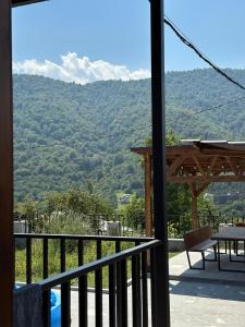 a balcony with a table and a view of a mountain at Dili Hill in Dilijan