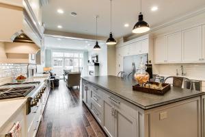 a kitchen with white cabinets and a large island at The Sono Chicago in Chicago