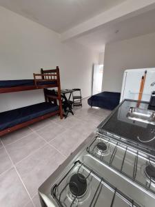 a kitchen with a stove top in a room at Casa da Maria Ubatuba in Ubatuba