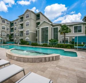 a large apartment building with a swimming pool at Resort Style Apt/Home in Houston Medical Centre in Houston