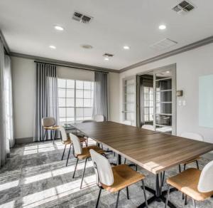 a conference room with a wooden table and chairs at Resort Style Apt/Home in Houston Medical Centre in Houston +44 photos