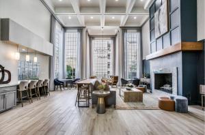 an office lobby with a fireplace and a dining area at Resort Style Apt/Home in Houston Medical Centre in Houston