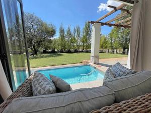 a patio with a couch and a swimming pool at House 41 at Pont de Val in Parys