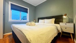 a bedroom with a large bed with two towels on it at Cozy apartment with free parking in Jar