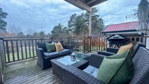 a patio with two chairs and a table on a deck at Cozy apartment with free parking in Jar