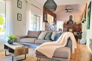 a living room with a couch and a table at Bakery Cottage Moyhu in Moyhu