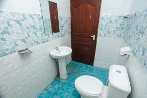 a bathroom with a toilet and a sink at 2 Bedroom Apartment in Links Road Nyali in Mombasa
