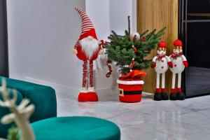 a room with a christmas tree and a santa clause at Nowoczesne Apartamenty typu Superior - Bulwary Rabka Zdrój - Balia - Blisko Park Zdrojowy in Rabka