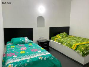 Una cama o camas en una habitación de Hospedaje DJ