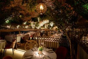 a restaurant with white tables and chairs and lights at ICON Wipton in Madrid