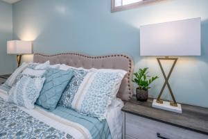 a bedroom with a bed with a lamp and pillows at Family Stay! Near both Ark & Creation Museum! in Walton