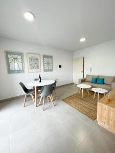 a living room with two tables and a couch at Saavedra 118 8D by depptö in Bahía Blanca +2 photos