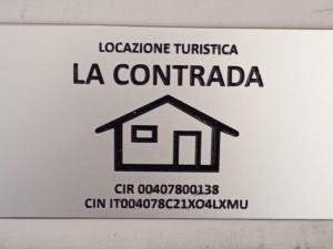 a white sign with a house on it at La contrada in Cuneo