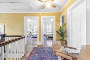a living room with yellow walls and a ceiling fan at Remodeled Farmhouse, Central, with Yoga room in Durham