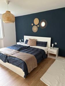 a bedroom with a large bed with a blue wall at Ferienwohnung an der Aitrach in Aitrach