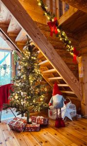 a christmas tree in a room with a staircase at Brīvdienu māja Straumēni in Pāle