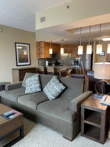 a living room with a couch and a kitchen at Grand Summit Hotel, Ski In Out, Pool, Hot Tub, Gym, Perfect Location! in Park City