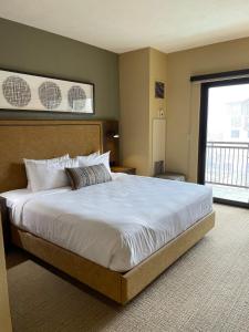 a bedroom with a large bed with a large window at Grand Summit Hotel, Ski In Out, Pool, Hot Tub, Gym, Perfect Location! in Park City