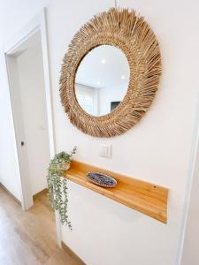 a mirror on a white wall with a wooden counter at El rincón de María in Torremolinos