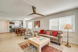 a living room with a couch and a table at Lanai and Golf Course View Cozy Condo in Naples! in Naples