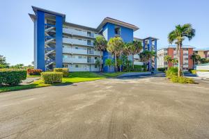 an empty street in front of a building with palm trees at Lanai and Golf Course View Cozy Condo in Naples! in Naples