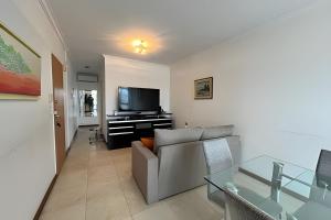 a living room with a couch and a flat screen tv at Moderno departamento zona centro in Rosario +8 photos