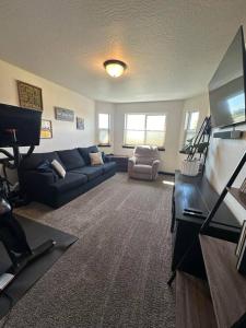 a living room with a couch and a tv at New home close to everything! in Coeur d'Alene