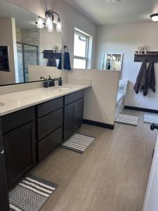 a bathroom with a sink and a large mirror at New home close to everything! in Coeur d'Alene