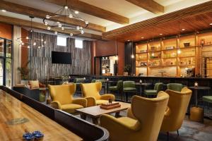 a restaurant with yellow chairs and a bar at The Red Cliffs Lodge Zion, a Tribute Portfolio Hotel in Springdale