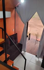 a view from inside a tent with a couch at Chalé Henri Salvador na Vinícola Reconvexo in Morro do Chapéu