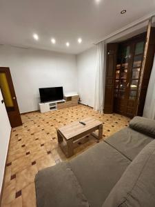 a living room with a couch and a coffee table at Mercado Chico SUITES in Avila