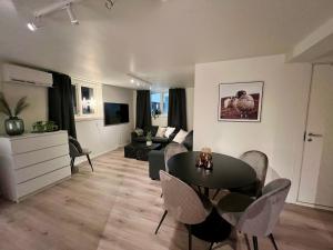 a living room with a table and a couch at Polar - TAG-apartments in Tromsø